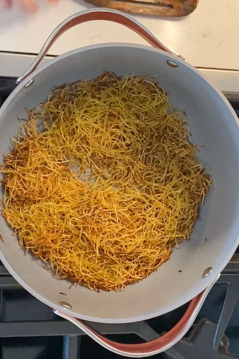 In a large Dutch oven on medium high heat, add the oil and wait for it to shimmer. Add the pasta and fry until golden brown, tossing frequently, for 3-4 minutes.