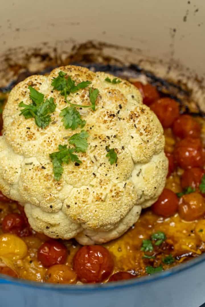 This Whole Roasted Cauliflower Recipe is made with a head of cauliflower, tomatoes, butter, onion, white wine, garlic and parsley.