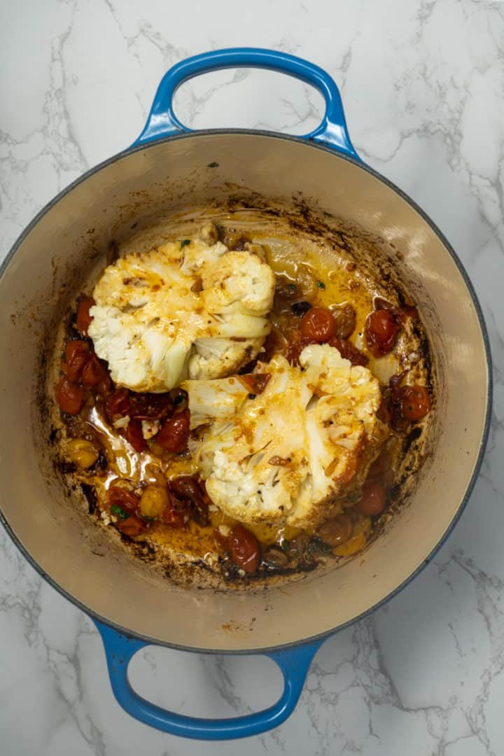 This Whole Roasted Cauliflower with Butter Sauce is made with a head of cauliflower, cherry tomatoes, butter, onion, white wine, garlic and parsley.