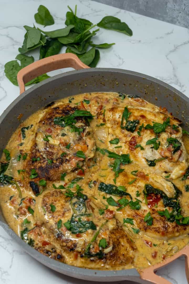 Take the chicken back out and set aside on a plate. Turn heat off and stir in the cream and parmesan in the sauce. Stir well and pour that sauce over the chicken. Enjoy this Creamy Marry Me Chicken with Sun-dried Tomatoes. 