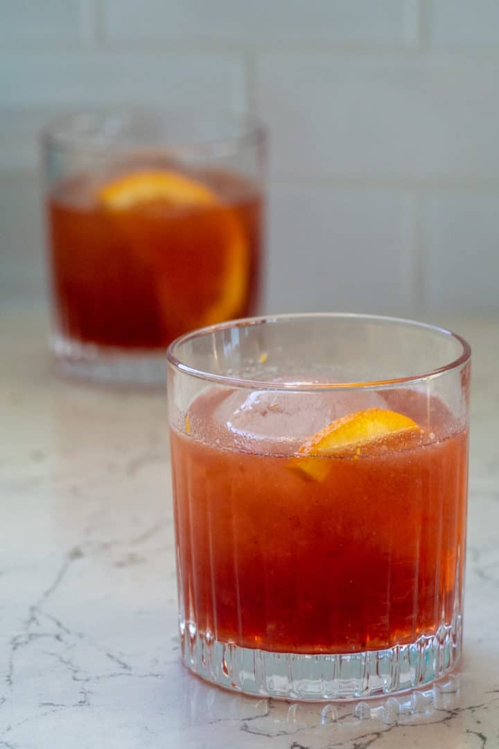 Add ice into small whiskey glasses and serve. Garnish with orange slices.  Enjoy this Cranberry Whiskey Sour. 
