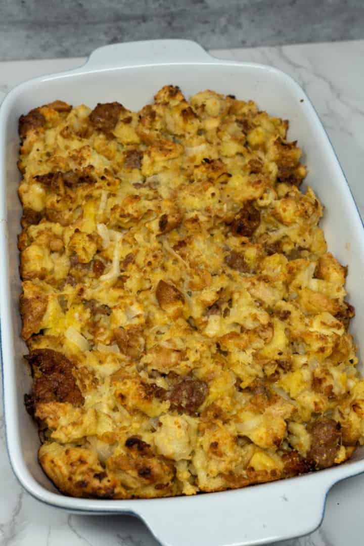 This Homemade Stuffing with Italian Sausage is made with Kaiser rolls, eggs, onions, parmesan cheese, Italian sausage, milk, and baked to perfection.