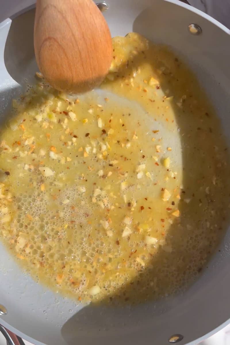 In a large saucepan, combine the butter, garlic and red pepper flakes on medium low heat. Cook and stir often, until the butter is melted and the garlic is fragrant, about 5 minutes. 