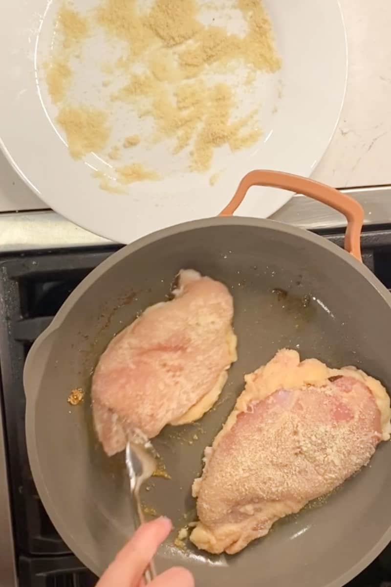 In a shallow plate, add the almond flour and dredge all four pieces of chicken in the flour. If you need more flour, feel free to use more. In a large saucepan on medium high heat, add oil and wait for it to shimmer. Brown the chicken on both sides, about 4 minds on each side, and set aside on a plate. (Chicken does not need to be cooked through yet). You may need to brown the chicken in batches.