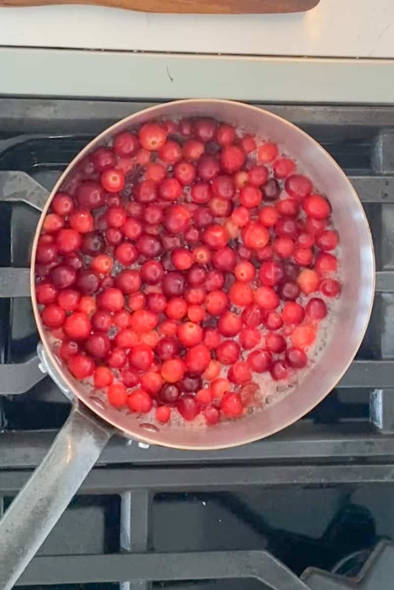 In a medium pot, bring ½ cup water, the maple syrup and cranberries to boil over high heat. Boil for 5 minutes, until the cranberries begin to burst. 