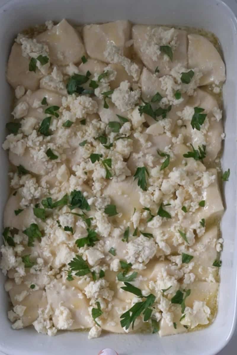 Place the pieces in the pie plate and toss to coat in the butter. Sprinkle blue cheese on top over the dough, as well as the parsley.