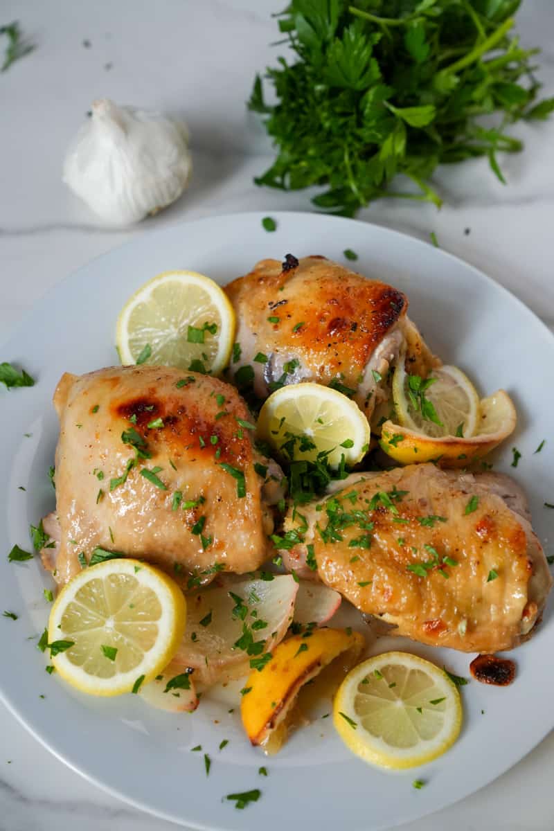 This Italian Dressing Chicken Recipe is made with bone in chicken thighs, a bottle of italian dressing, onions, and lemons.