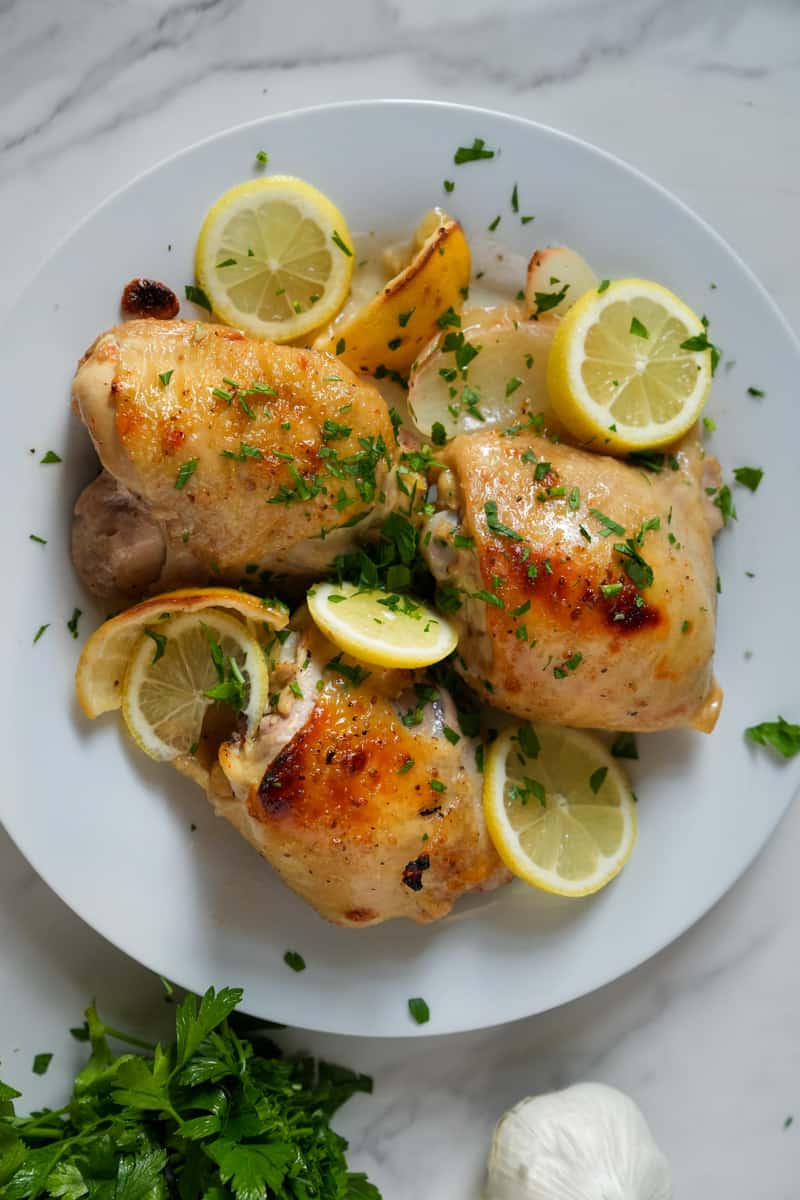 This Italian Dressing Chicken Recipe is made with bone in chicken thighs, a bottle of italian dressing, onions, and lemons.