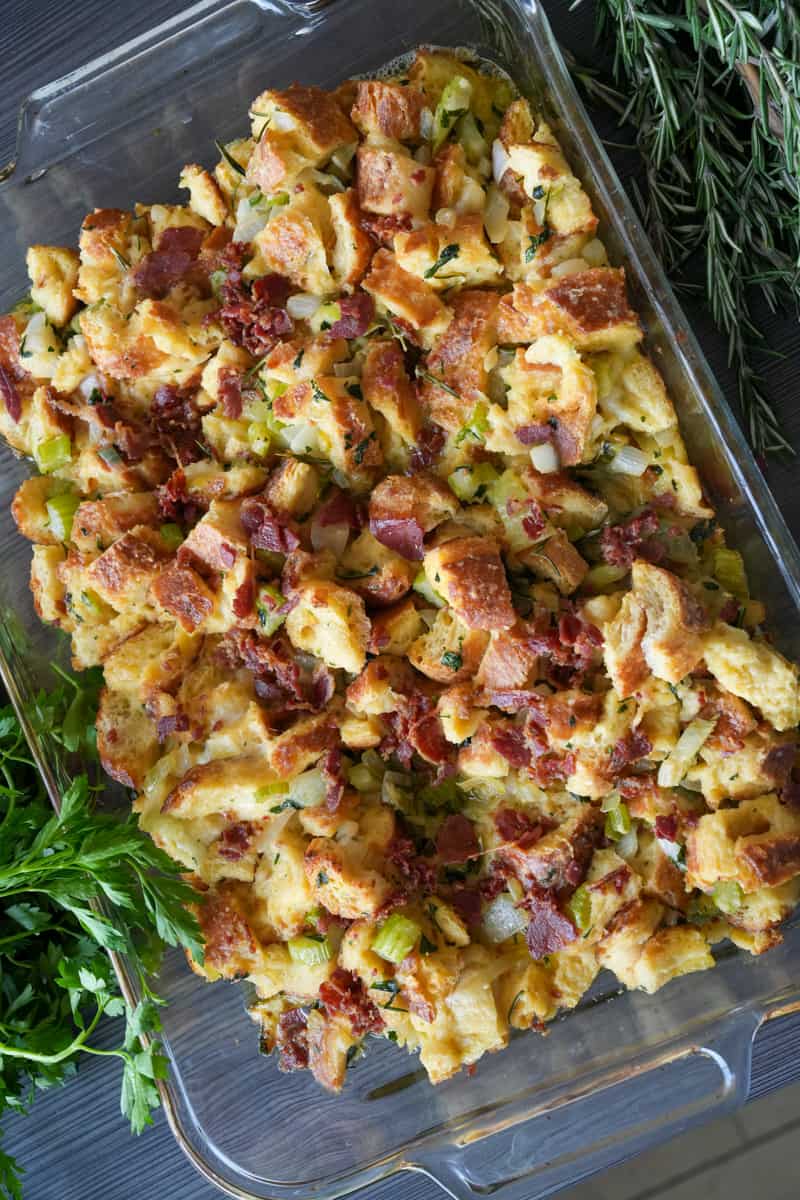 This Sausage and Herb Stuffing Recipe is made with Kaiser rolls, eggs, onions, parsley, rosemary, parmesan, Italian sausage, and milk.