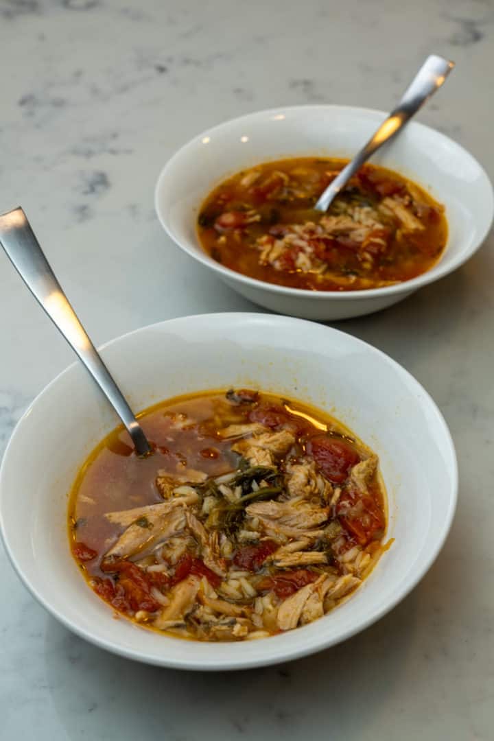 This Instant Pot Chicken Soup with Frozen Chicken is made using frozen chicken, onion, garlic, broth, spinach, diced tomatoes and rice.