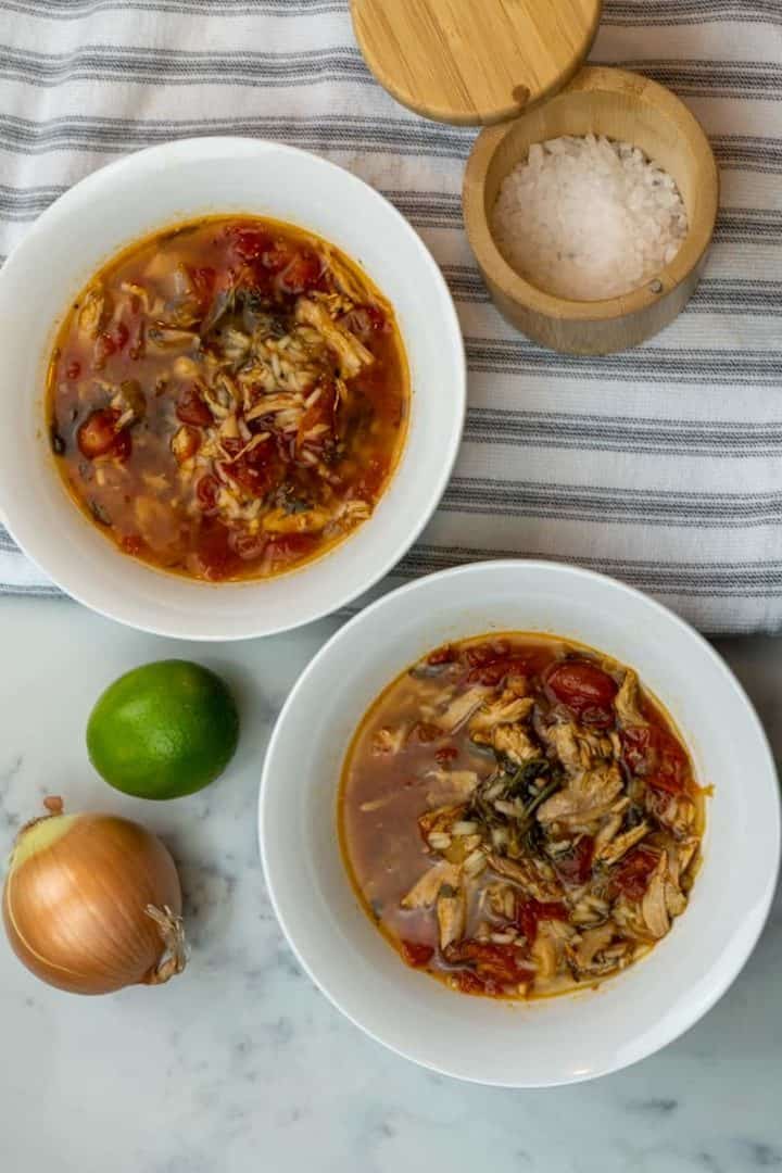 This Instant Pot Chicken Soup with Frozen Chicken is made using frozen chicken, onion, garlic, broth, spinach, diced tomatoes and rice.