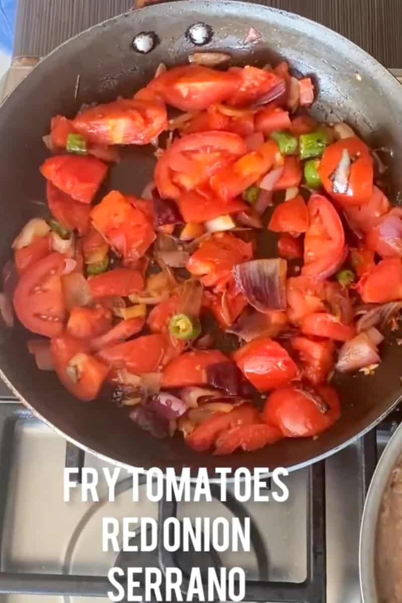 In a large deep skillet on medium heat, add oil and wait for it to shimmer. Stir in the onion, garlic, and serrano pepper and cook until the onion is soft, about 3-5 minutes. Add the tomatoes and cook altogether, for another 6 minutes, until the tomatoes begin to soften up. 