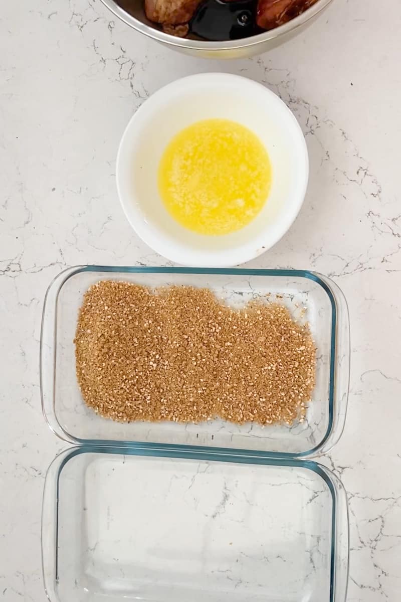 Preheat the oven to 375 F. In a large plate or tray, add all of the corn flakes and crush them with your hands until you get small pieces that will stick to the chicken. Add the garlic powder into the corn flakes and keep crushing and mixing with your hands. 