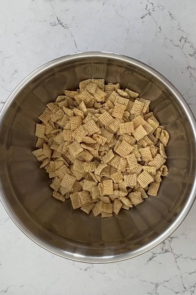 Add the Chex cereal in a large Ziplock bag or a large mixing bowl with a lid. Set aside.