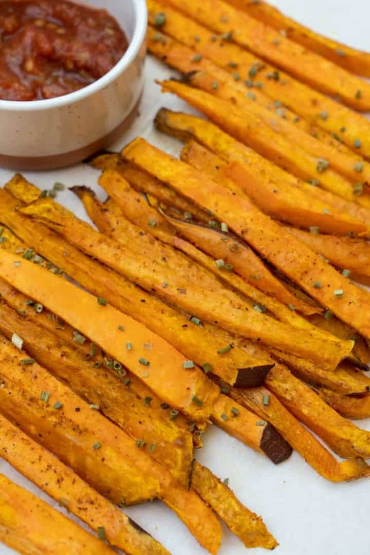 Air fry until golden brown and crispy on the outside. Timing varies on the air fryer. Garnish with freeze drives chives and serve with your favorite condiment, like ketchup or ranch. Enjoy these Air Fryer Sweet Potato Fries.