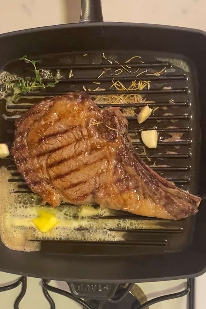 Add the butter, garlic, and thyme and swirl in the pan until the butter melts. Transfer herbs and garlic on top of steak and baste the steak using a large spoon. Keep basting for 1 minute and baste the other side for 30 seconds.
