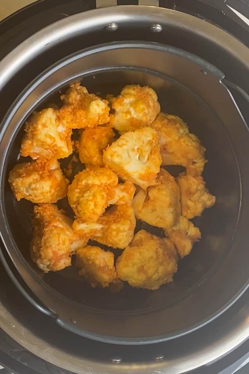 Air fry at 350˚F for 15 minutes, shaking a couple times during the cooking process. Cauliflower is done when the florets are a bit browned, but not mushy.