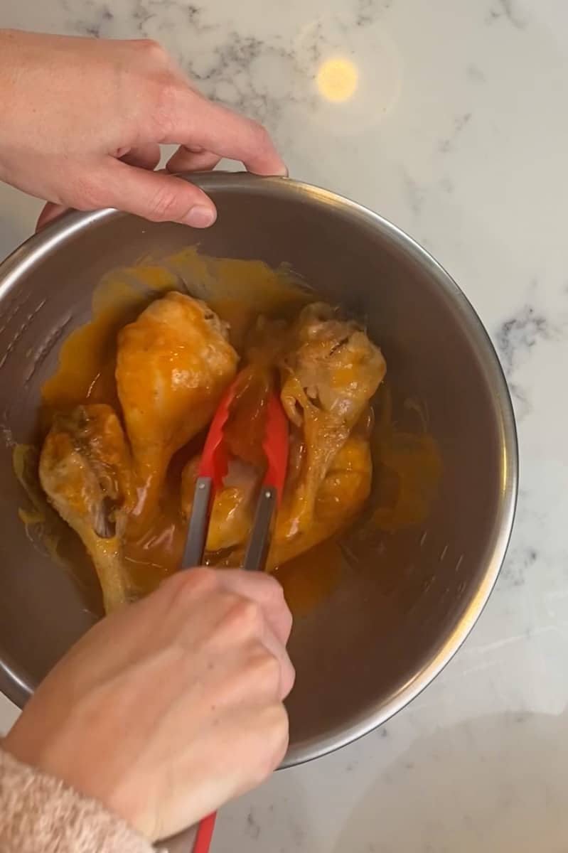 Remove the air fried chicken from the fryer and place in a bowl. Drizzle the buffalo sauce over the chicken and toss well to combine. 