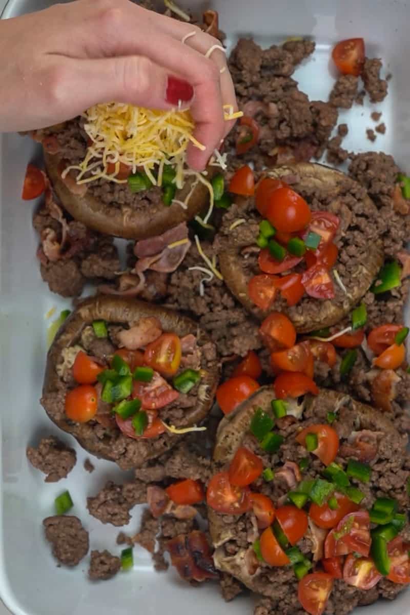 Place the portobello mushrooms on a baking pan and drizzle olive oil over each. Place the filling on top of each mushroom evenly. You can add more cheese on top if you wish! Place them in the oven for 10 minutes. 
