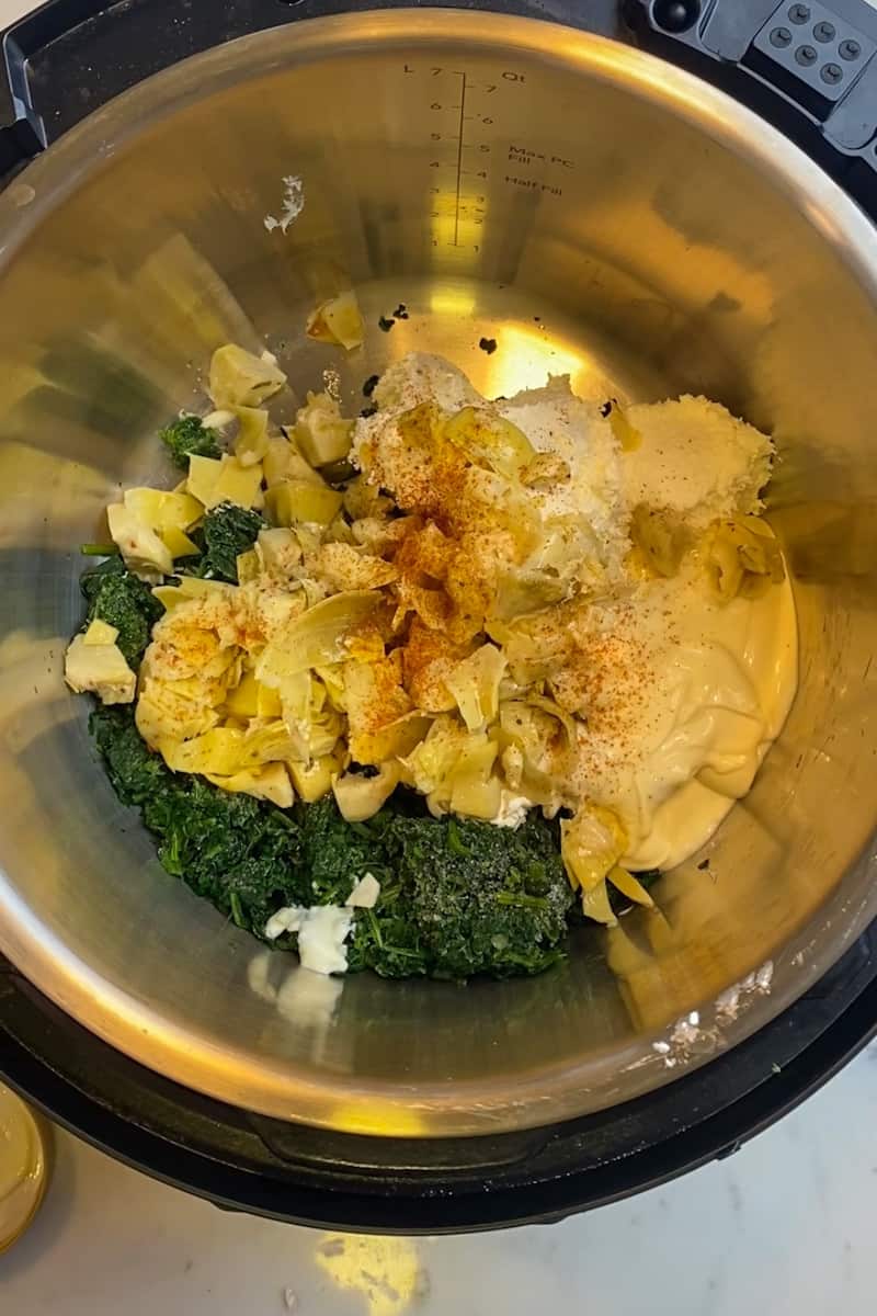 Add the spinach, cream cheese, mayonnaise, chopped artichokes, chili powder, Yondu Vegetable Umami, water and garlic in the Instant Pot and combine.