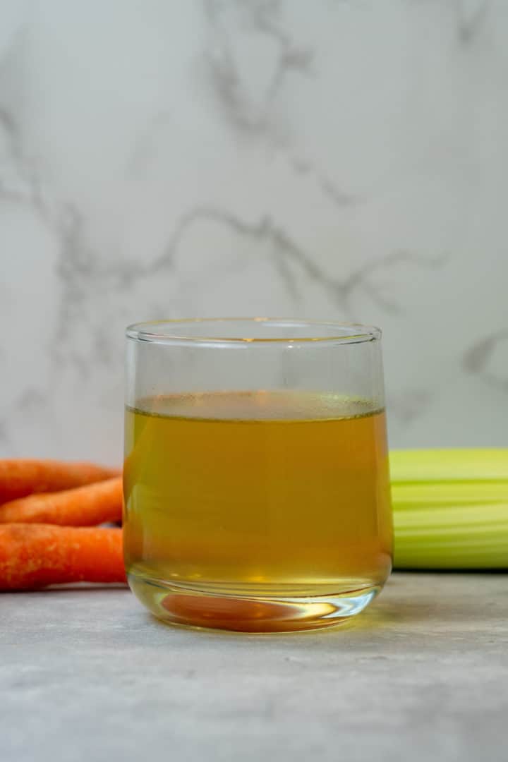 This Bone Broth Recipe (Instant Pot) is made with a carcass of a chicken, carrots, celery, and herbs in an Instant Pot.