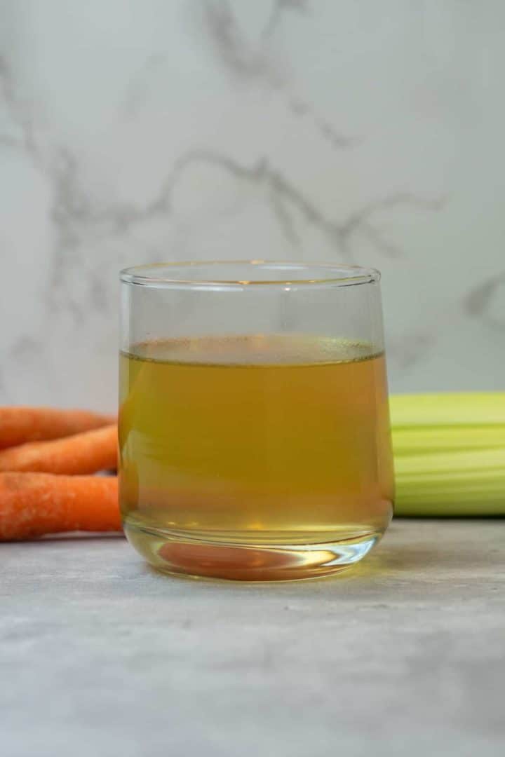 This Fast Bone Broth with Rotisserie Chicken (Instant Pot) is made with a carcass of a chicken, water, carrots, celery, apple cider vinegar, herbs, and bay leaves in a pressure cooker.