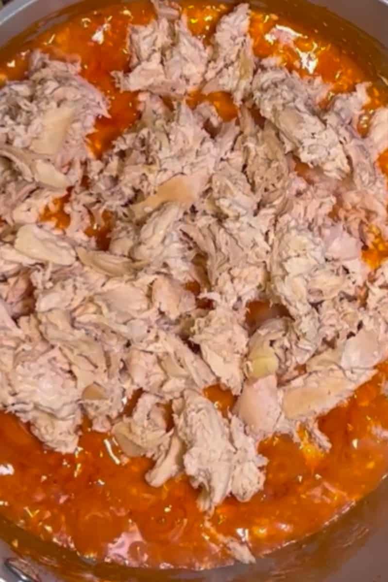 Toss in the shredded chicken and cook until thickened.