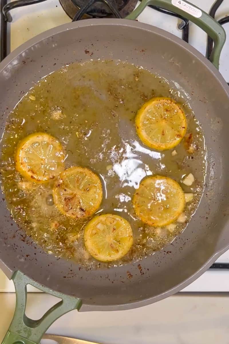 Lower heat. Using the same pan and the same juice, add 2 tablespoons of butter. Once the butter melts, add the garlic and white wine. After three minutes, add the juice of two lemons, capers and parsley. 