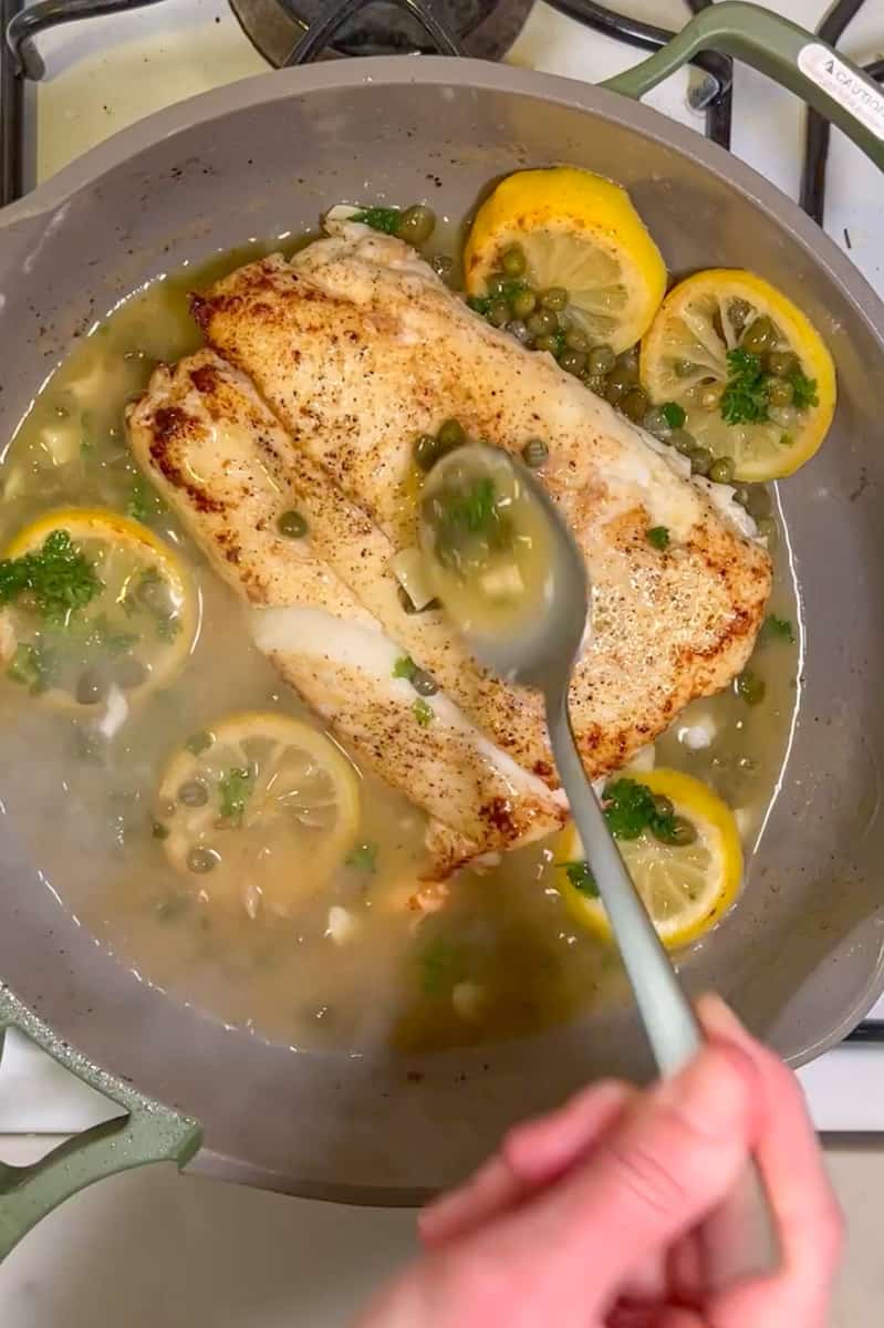 Add the halibut back on the pan and scoop the juice over and over again onto the halibut. Place the lemon onto to plate.