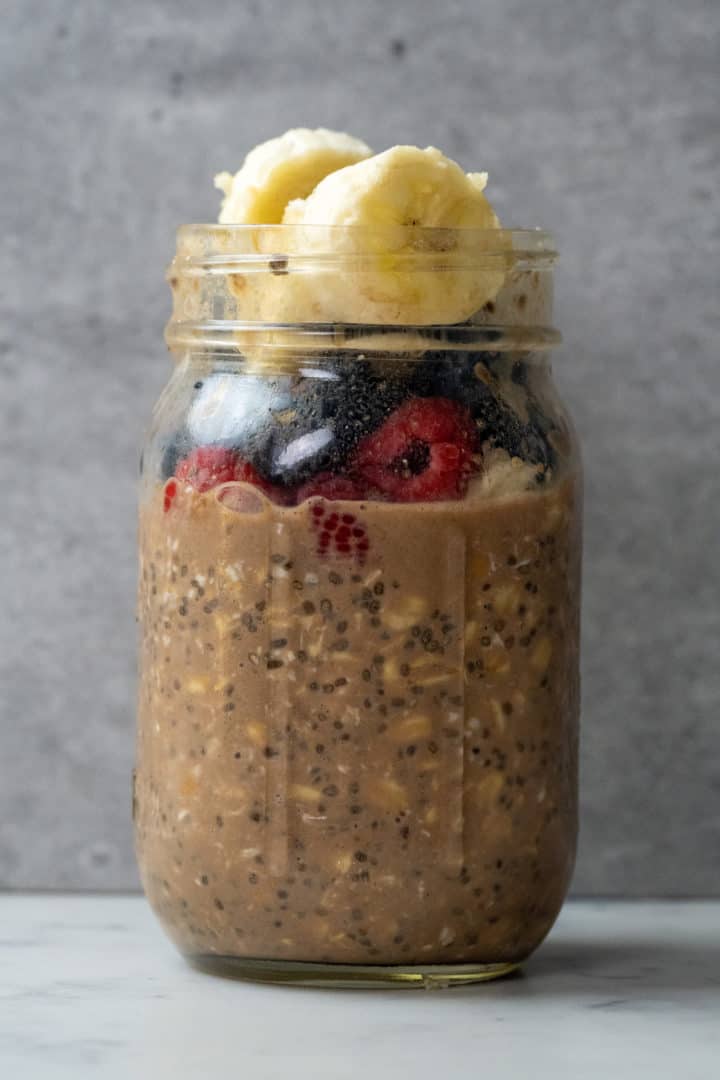 These Overnight Oats with Protein Powder and Peanut Butter are made with old fashioned oats, almond or oat milk, protein powder, chia seeds, maple syrup, berries, chopped nuts, and peanut butter.