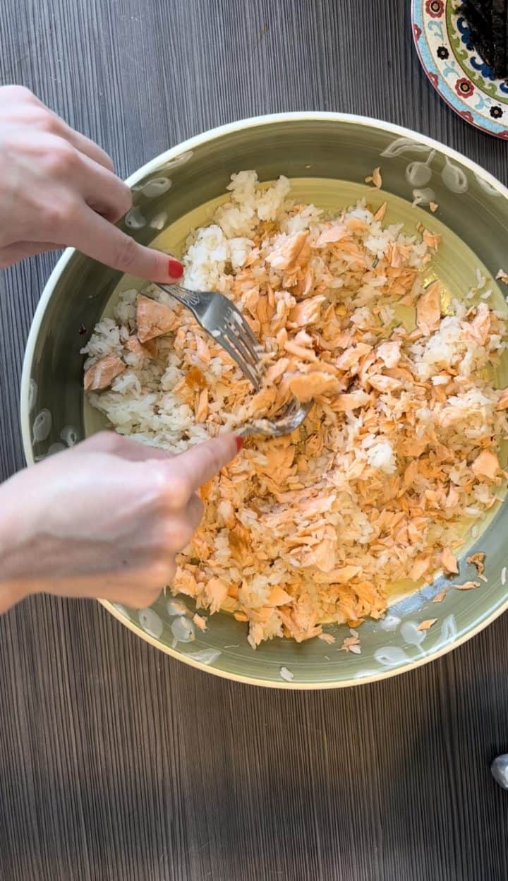 With two forks, use the fork to flake the fish and mix it up in the rice. 