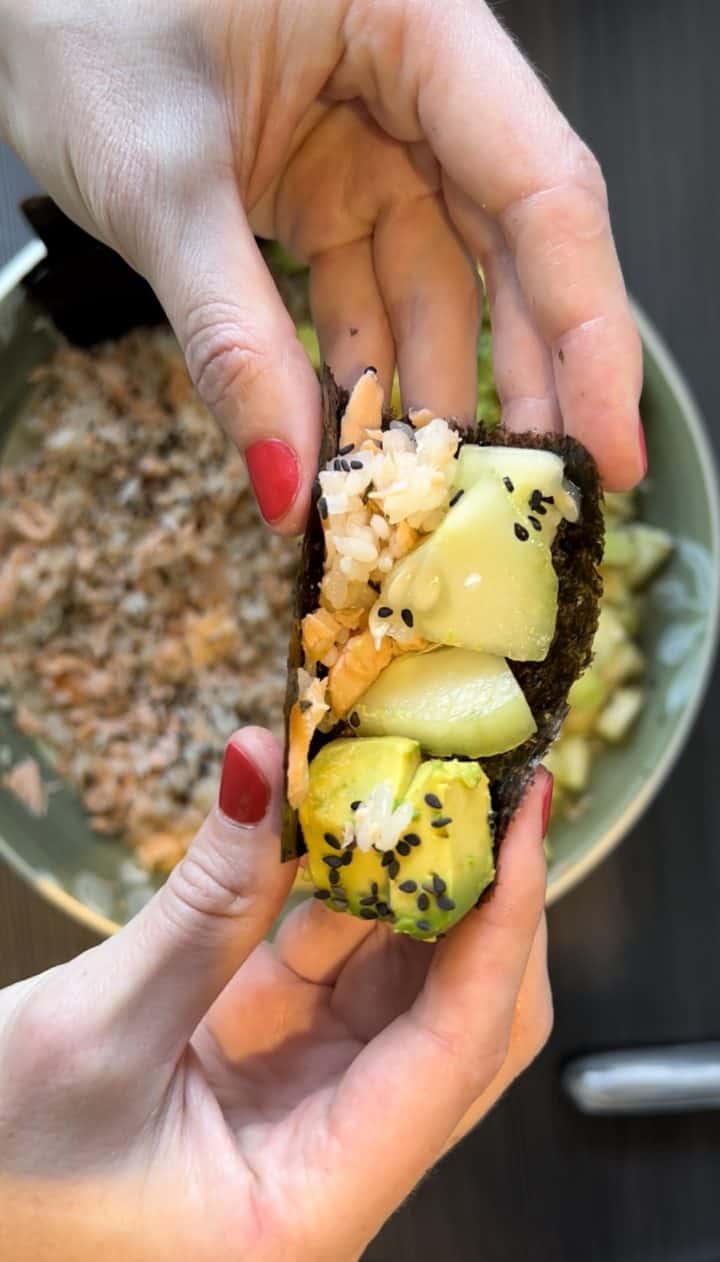 Grab a piece of seaweed snacks and place the salmon mixture into it, like a taco. Top with cucumbers and avocado as needed, and enjoy.