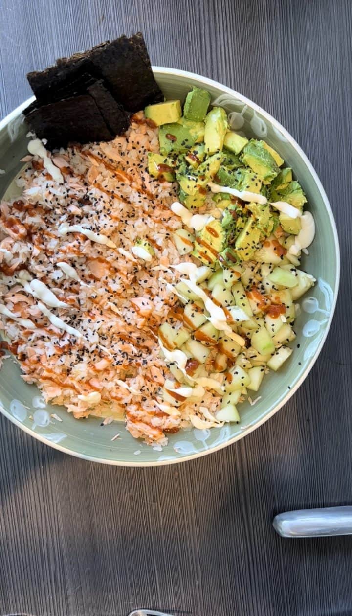 This Salmon Rice Bowl is made with salmon, sushi rice, diced cucumber, diced avocado, sesame and served on individual seaweed snacks.