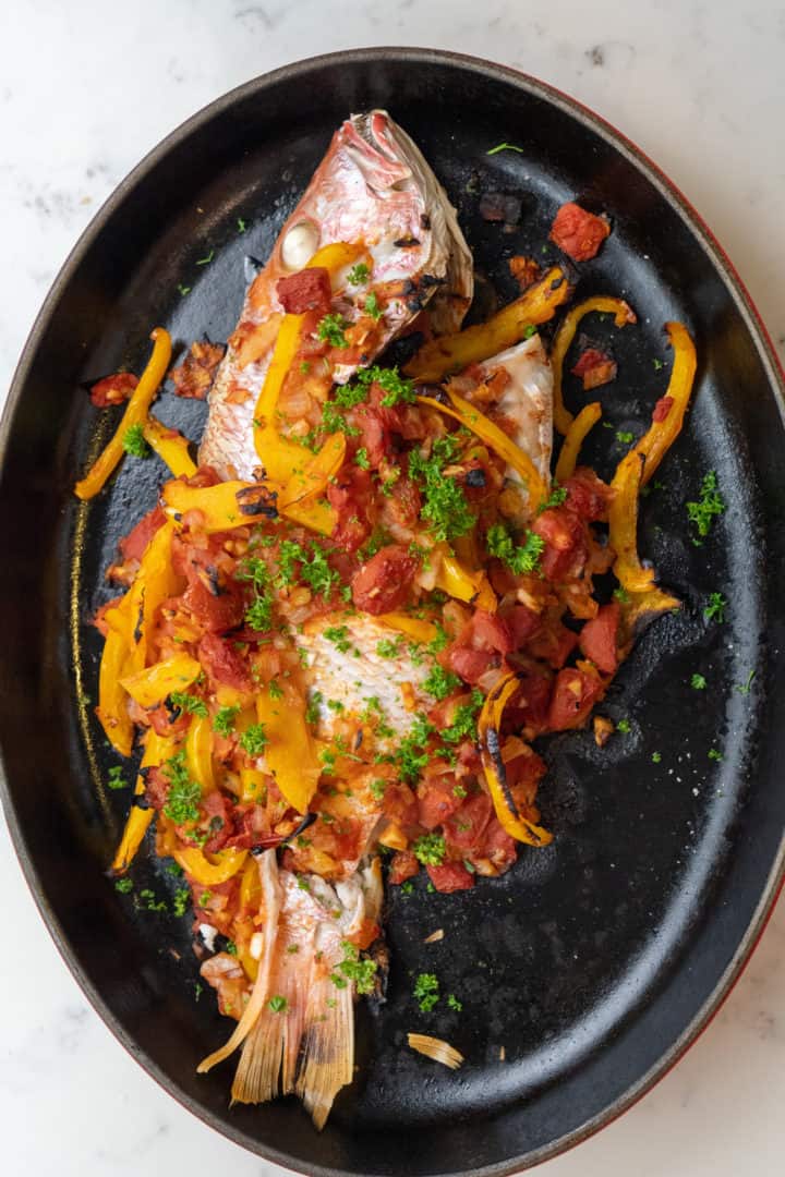 This Mexican Fish Recipe is a Veracruzana style fish made with a whole red snapper, lime juice, tomatoes, onion, bell pepper, and is baked to perfection.