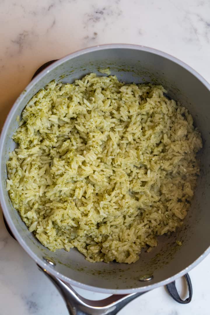 This pesto rice is made with basil leaves, pine nuts, garlic, olive oil, parmesan cheese, basmati rice and lemon juice.
