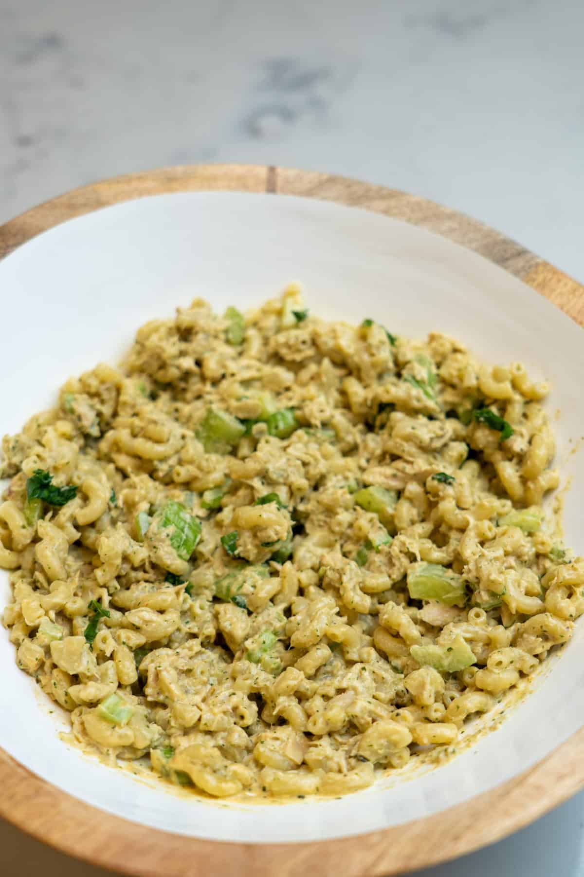 This Canned Tuna Pasta Recipe is made with tuna, pasta, basil, nuts, garlic, olive oil, parmesan, greek yogurt and lemon juice.