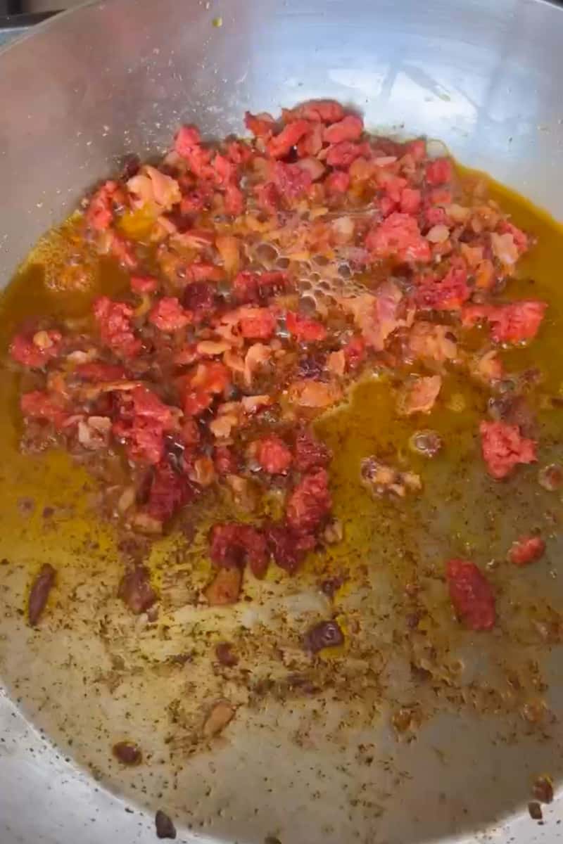 In a large dutch oven on medium heat, add the chopped bacon and crumbles sausage. Cook until this is brown, about 10-12 minutes. With a slotted spoon, remove the meat but leave the excess fat in the pot. 