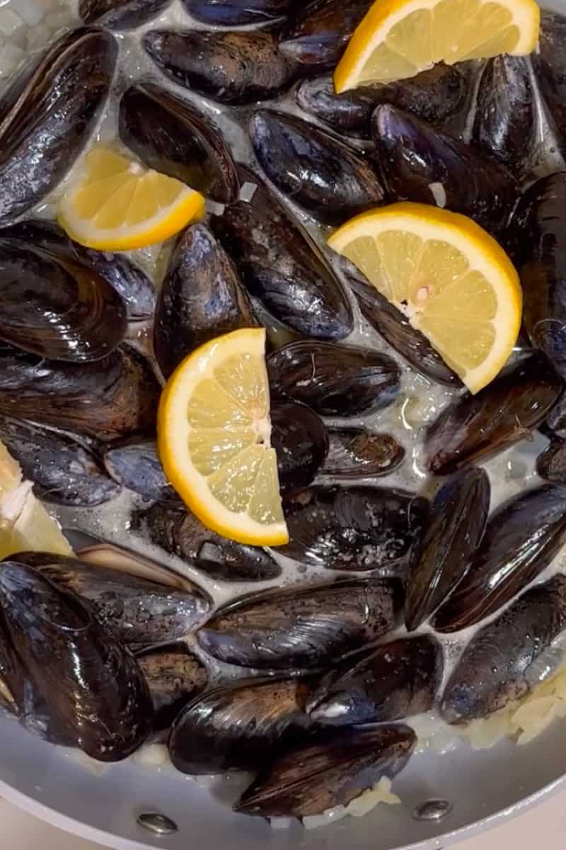 Add the mussels and lime wedges. Stir, cover and cook for 10 minutes, until the mussels open.