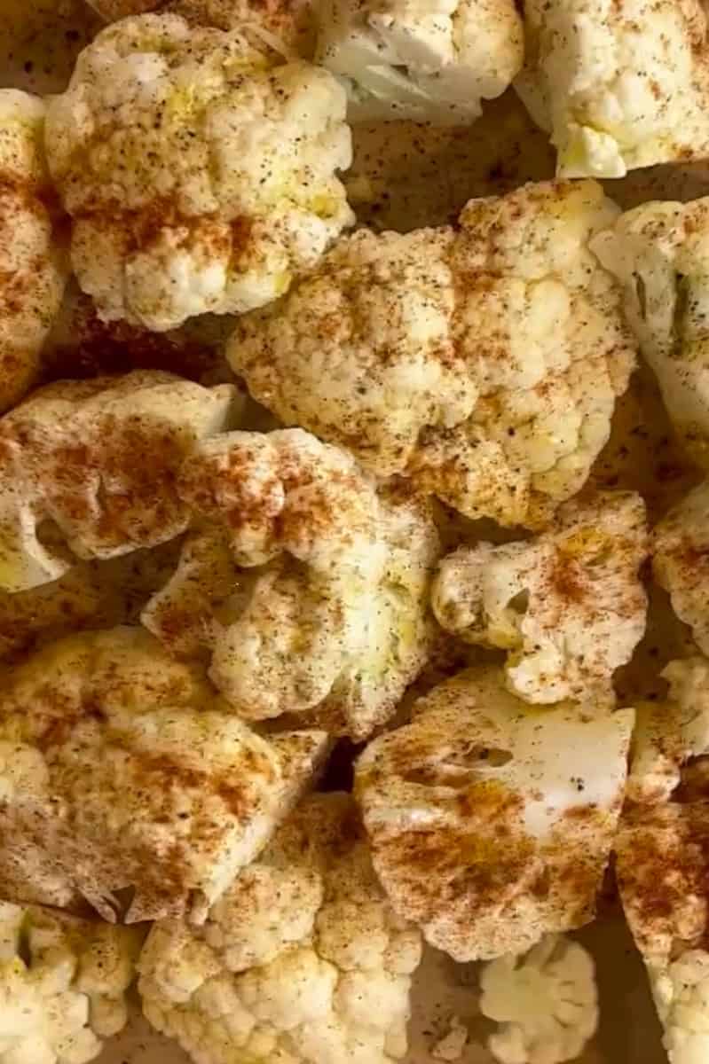 Preheat the oven to 425°F. In a large bowl, add the cauliflower and drizzle with olive oil. Toss in the salt, pepper and chili powder and shake to combine. On a baking sheet lined with parchment paper, add the cauliflower florets. Bake in the oven for about 15-20 minutes. Watch closely toward the end.