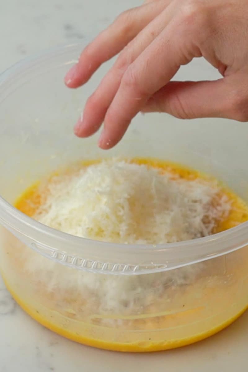 Place a large pot of salted water over high heat and bring to a boil. In a mixing bowl, whisk together the eggs, yolks, pecorino and parmesan. Season with salt and black pepper.