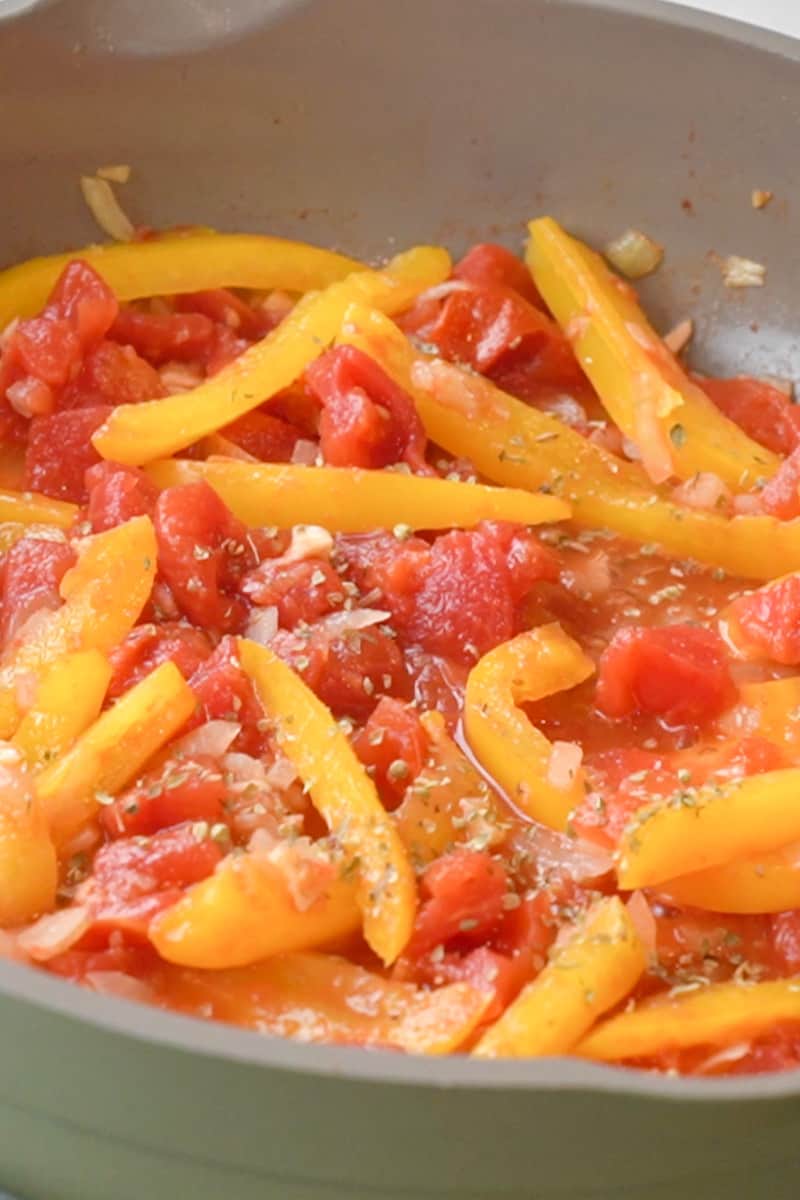 In a medium skillet on medium heat, add the oil and wait for it to shimmer. Add the onion, garlic and bell pepper and cook, stirring, until the onion is soft, about 3-5 minutes. Add the oregano and tomatoes and bring to a boil. Let it cook for about 5-7 minutes. Squeeze the lime juice into it and give it a nice stir.