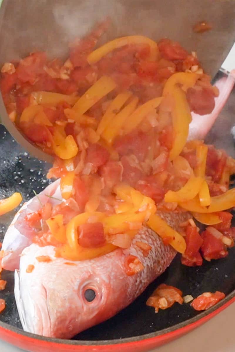 Pour the sauce over the fish and place the whole fish in the oven. Bake about 20-30 minutes, until the fish flakes with a fork and the flesh is opaque in the center.