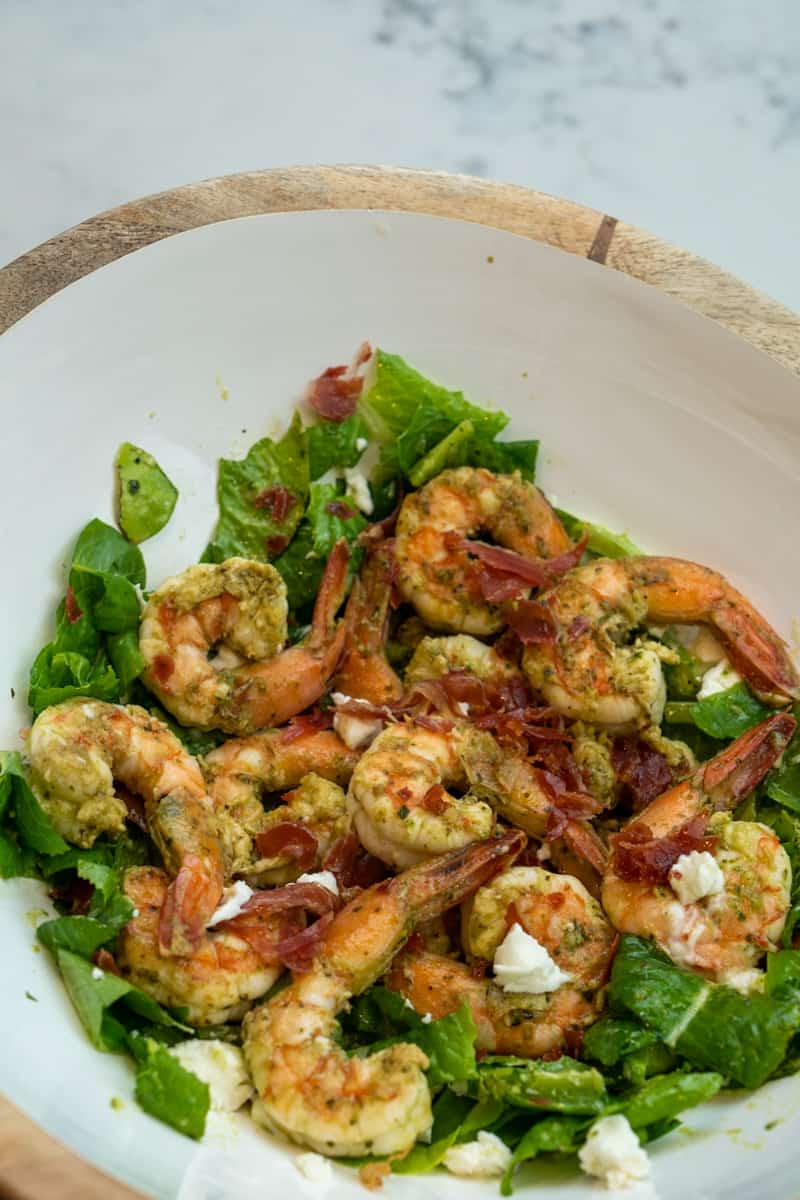 This Pesto Shrimp Salad with Lettuce is made with pesto, vinegar, parmesan cheese, butter, shrimp, goat cheese, lemon, and all tossed in chopped romaine.