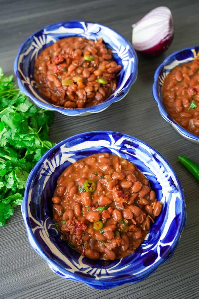 This Mexican Charro Beans Recipe, also known as Frijoles Charros, are made with pinto beans, chipotle, garlic, tomatoes, and cilantro.