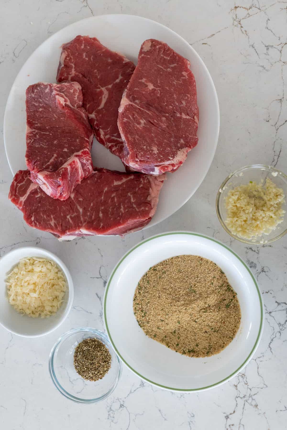 This Italian Breaded Steak is made with shell steaks, olive oil, garlic cloves, dried bread crumbs, parmesan, dried oregano and broiled.