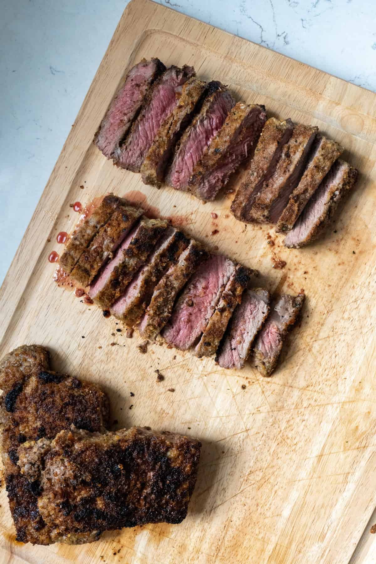 This Italian Steak Recipe is made with shell steaks, olive oil, garlic cloves, dried bread crumbs, parmesan, dried oregano and broiled.