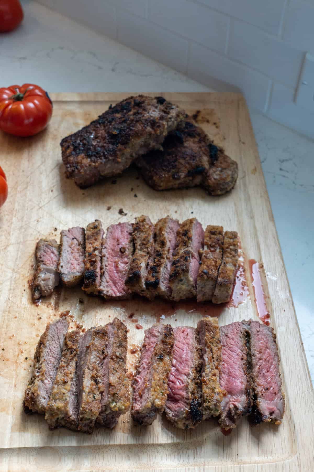 This Italian Steak Recipe is made with shell steaks, olive oil, garlic cloves, dried bread crumbs, parmesan, dried oregano and broiled.