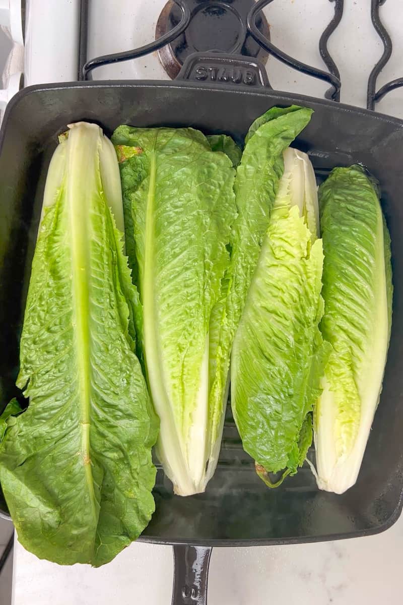 Place the romaine hearts on the grill cut-side down. If you are using a grill pan, you will need to do this in batches. Grill each side until lightly charred, about 3 to 4 minutes.