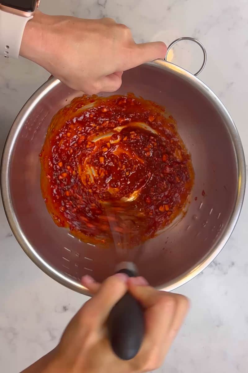 In a large bowl, mix the harissa, honey, ginger, and garlic and whisk together. Add the chicken inside the bowl and mix until coated. 