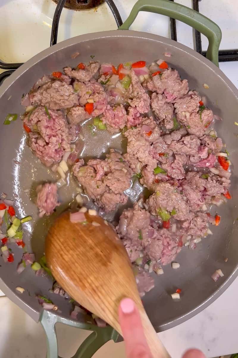 Add the ground lamb and cook all the way through, about 12-15 minutes, stirring frequently and breaking the ground lamb apart with a wooden spoon.